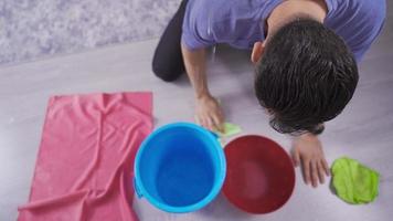 Man Looking At The Ceiling While Collecting The Water Leaking From The Ceiling In The Living Room At Home. video