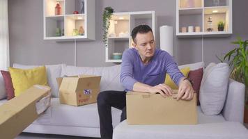 Man with back pain while lifting the box. Man with backache while lifting box at home. video