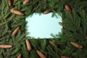 Holidays greeting card or banner composition with pine tree branches. Merry Christmas background and Happy New Year 2023. photo