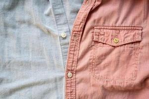 Different shirts are buttoned together. Fabric background in pink and grey. Place for text. Flatley. photo