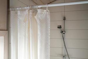 Waterproof curtain in the bathroom that covers the shower area. photo