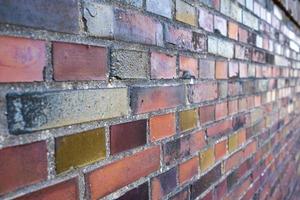 Old brickwork, some red bricks on the wall are painted, outdoors. Copy space. Abstract background. photo