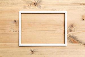 Rectangular blank white frame on wood texture. Abstract background. Copy space. Top view. photo