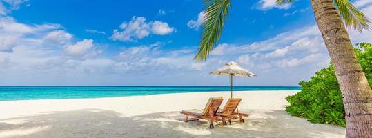 Beautiful panorama nature. Tropical sunny beach as summer island landscape couple chairs umbrella palm leaves calm sea shore, coast. Romantic travel panoramic destination, togetherness vacation banner photo