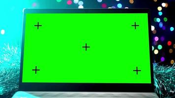 Laptop with Green Screen and Colored Key against the Background of Glowing Garlands and New Year's Decorations. Winter Holidays Concept. video