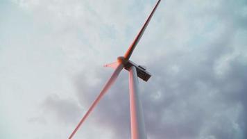 The windmill is spinning against the backdrop of a beautiful cloudy sky. Alternative energy concept. Wind power plant. video