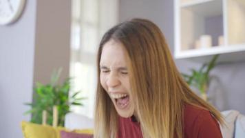 mujer gritando en casa drenando tus nervios. una mujer aprieta los dientes y luego grita mientras se esfuerza y empuja. video