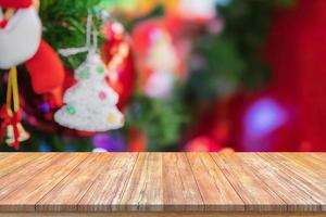 Empty wood table top with blur Christmas tree with bokeh light background photo