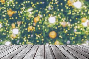 Empty wood table top with blur Christmas tree with bokeh light background photo