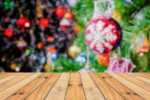 Empty wood table top with blur Christmas tree with bokeh light background photo