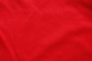 Fondo de textura de jersey de camiseta de fútbol de tela de ropa deportiva roja foto