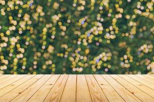 Empty wood table top with blur Christmas tree with bokeh light background photo