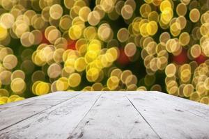 Empty wood table top with blur Christmas tree with bokeh light background photo