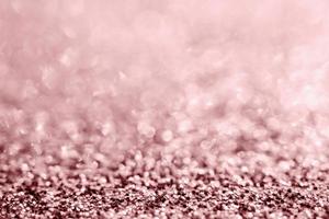 Abstract rose gold glitter sparkle texture with bokeh background photo