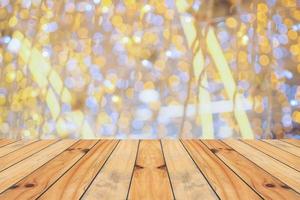 Empty wood table top with blur Christmas tree with bokeh light background photo