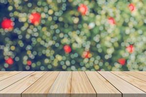 Empty wood table top with blur Christmas tree with bokeh light background photo