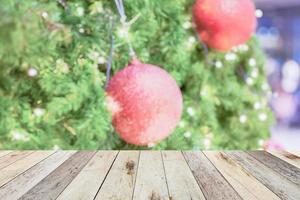 Empty wood table top with blur Christmas tree with bokeh light background photo