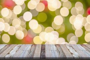 Empty wood table top with blur Christmas tree with bokeh light background photo