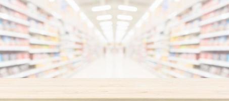 Wood table top with supermarket grocery store blurred background with bokeh light for product display photo