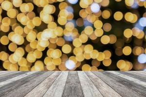 Empty wood table top with blur Christmas tree with bokeh light background photo