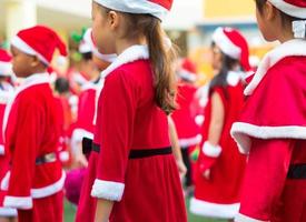 Girls in red theme costume in Christmas party of elementary school photo