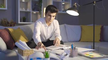 Man working late at night in living room at home. Tired young man working in dark home office. Freelancer. video