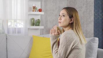 Thoughtful woman. Woman lifts her chin while sitting. Thoughtful woman sitting at home. video