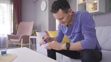 Applying cream to an irritated, chapped hand. The man is applying cream to his hand that is in pain. video