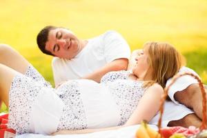 Pregnant couple relaxing photo