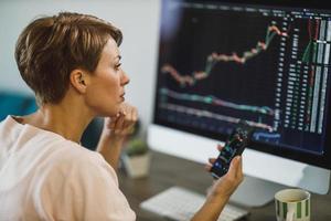 Business Woman Trading With Cryptocurrency From Home photo