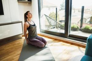 Woman Practicing A Stretching Yoga Exercises At Home photo