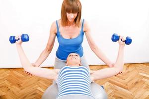 Exercising With a Personal Trainer photo