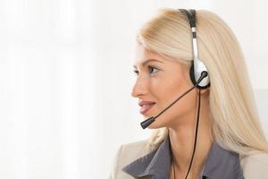 Young Blond Woman With A Headset photo