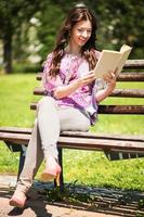 Woman Reading Book In The Park photo