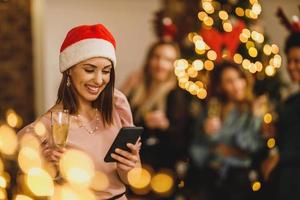 Woman Texting At A Christmas Party photo