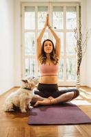 Woman Doing Yoga With Her Dog photo