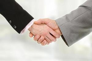 Closeup of business people shaking hands with each other photo