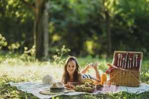 Little Girl Enjoying Day In Nature On Picnic photo