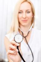 Female doctor holding stethoscope photo