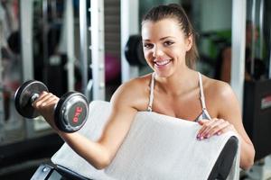 Young woman doing Biceps exercise photo