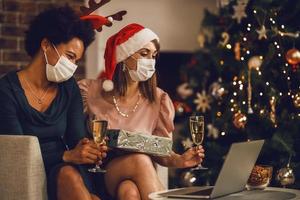 Two Women Making Christmas Video Call With Their Friends During Isolation photo