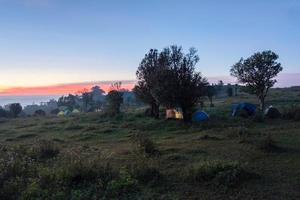 Camping tent tourist on hill mountain and sunrise background photo