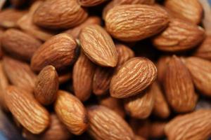 Almonds top view - Close up of roasted almond nuts background photo