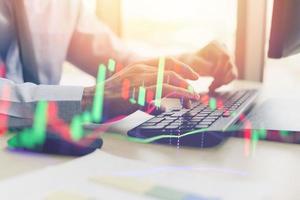 Close up of typing male hand on keyboard concept businessman investment entrepreneur trading online working on computer monitor trade Forex or Stock market exchange information trading graph chart photo