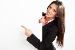 Businesswoman pointing on board photo