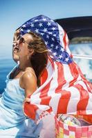 Woman With US National Flag Having Fun  On Private Yacht photo