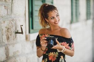 Portrait Of A Woman Tourist With Digital Camera photo