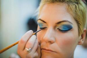 Makeup Artist Applying Makeup On A Model photo