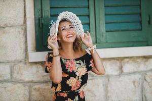 Portrait Of A Cheerful Woman Wearing Summer Hat photo