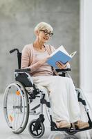 Disabled Senior Woman Reading Book photo